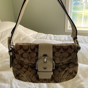 Tan and white Coach purse.